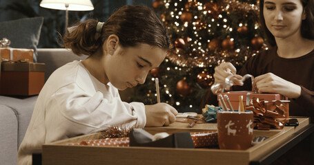 Sisters preparing Christmas gifts together