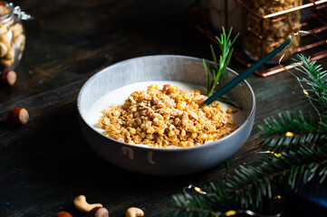Christmas breakfast consists of granola with yogurt. Christmas muesli with nuts. Winter holidays concept. Healthy food. Oatmeal snack
