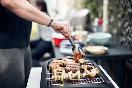 Preparing barbeque on a electrical modern grill outdoors.