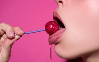 Close up, model licking a red lollipop