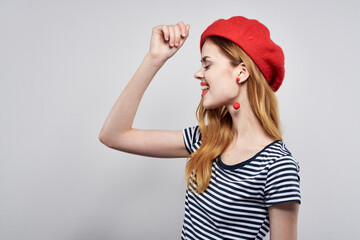 pretty woman in a striped t-shirt red lips gesture with his hands model studio