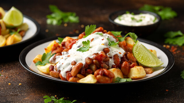 Spicy Bean Chilli with Baked Potato, sour cream and lime. Healthy Food