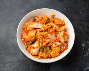 Traditional Korean Kimchi Cabbage in white bowl. Healthy food.