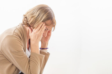 Woman having headache and touching her head while suffering from a migraine