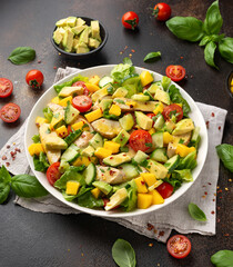 Tasty Chicken mango salad with avocado, cucumber, cherry tomatoes. Healthy food