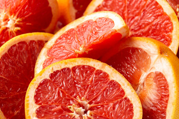 Juicy Grapefruit slices on rustick dark background. Healthy food.