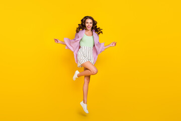 Fototapeta na wymiar Full length body size photo careless woman jumping high in stylish outfit isolated bright yellow color background