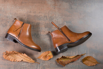 brown shoes lie on a grunge surface as if walking through foliage, shopping and discount concept