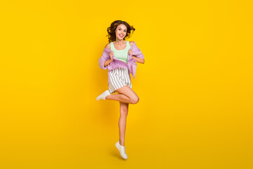 Full length body size photo woman jumping up in casual clothes summer isolated bright yellow color background