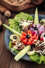 Caucasian snack appetizer platter with vegetables on wooden background