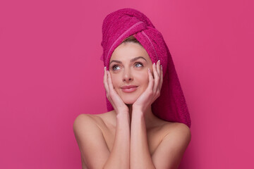 Cosmetic cream on woman face with clean soft skin. Body care. Woman with pink towel applying cream on skin. Body care and spa salon concept. Spa girl. Beautiful young woman with perfect skin.