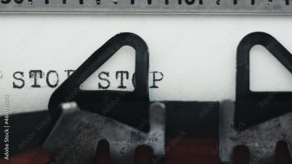 Poster typing word stop on retro typewriter over and over again. black ink on white paper retro text style