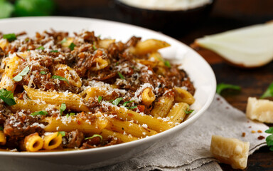 Pasta alla Genovese on a white bowl with parmesan cheese. Traditional neapolitan food.