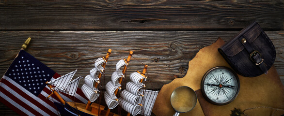 Columbus Day. Vintage discovery equipment with copy space on dark wooden background.