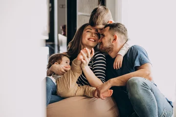 Fotobehang Young family with their sons at home having fun © Petro