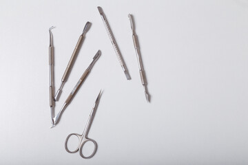 Set of disinfected manicure or pedicure tools. Cuticle pushers and scissors for safe hygiene, beauty and nails care. Top view. Copy space.