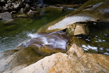 white rock bedrock with natural pool and green water,
salt del mir catalonia, spain