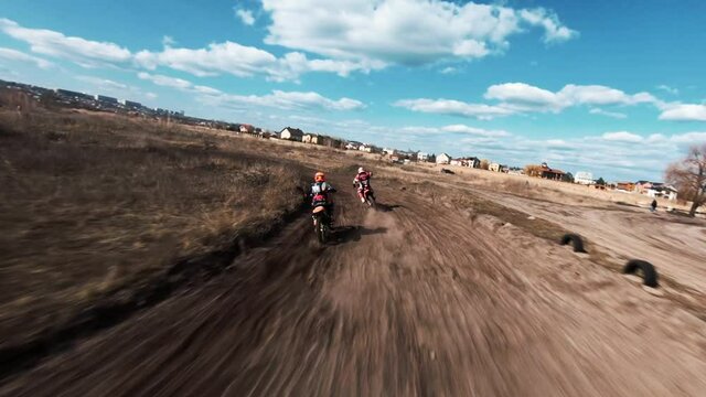 Motorcycles ride on gravel track, enduro competition
