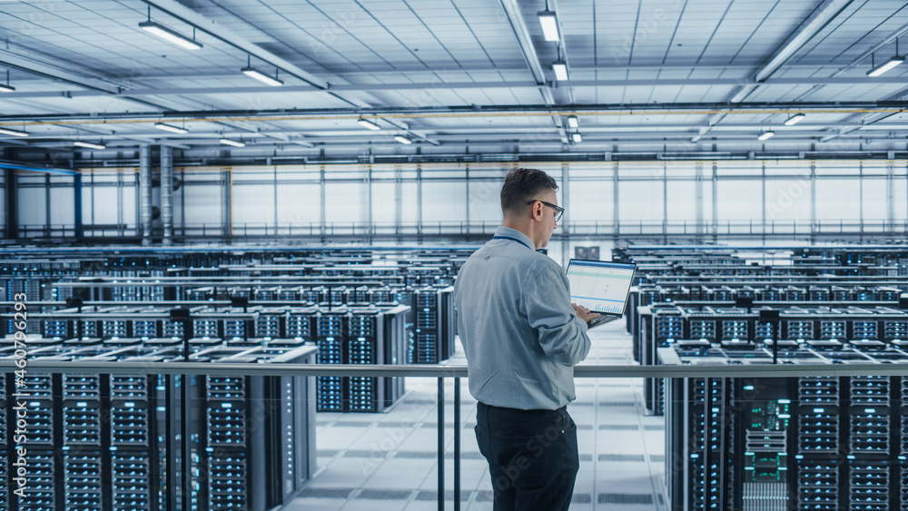 Aufkleber Data Center Engineer Using Laptop Computer. Server Farm Cloud Computing Specialist Facility with Adult Male System Administrator Working with Data Protection Network for Cyber Security.