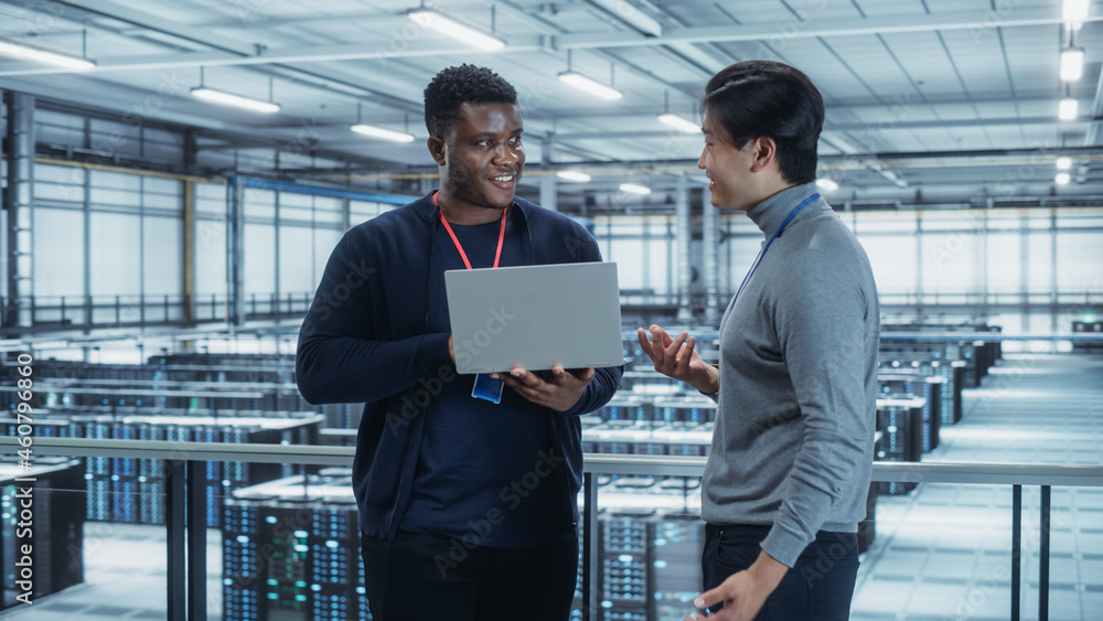 Aufkleber Two Multiethnic Male Data Center System Administrators and IT Specialists Talk, Use Laptop. Information Technology Engineers work on Cyber Security Network Protection in Cloud Computing Server Farm.