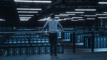 Data Center Engineer Looking Down from a Balcony on Server Farm Cloud Computing Specialist...