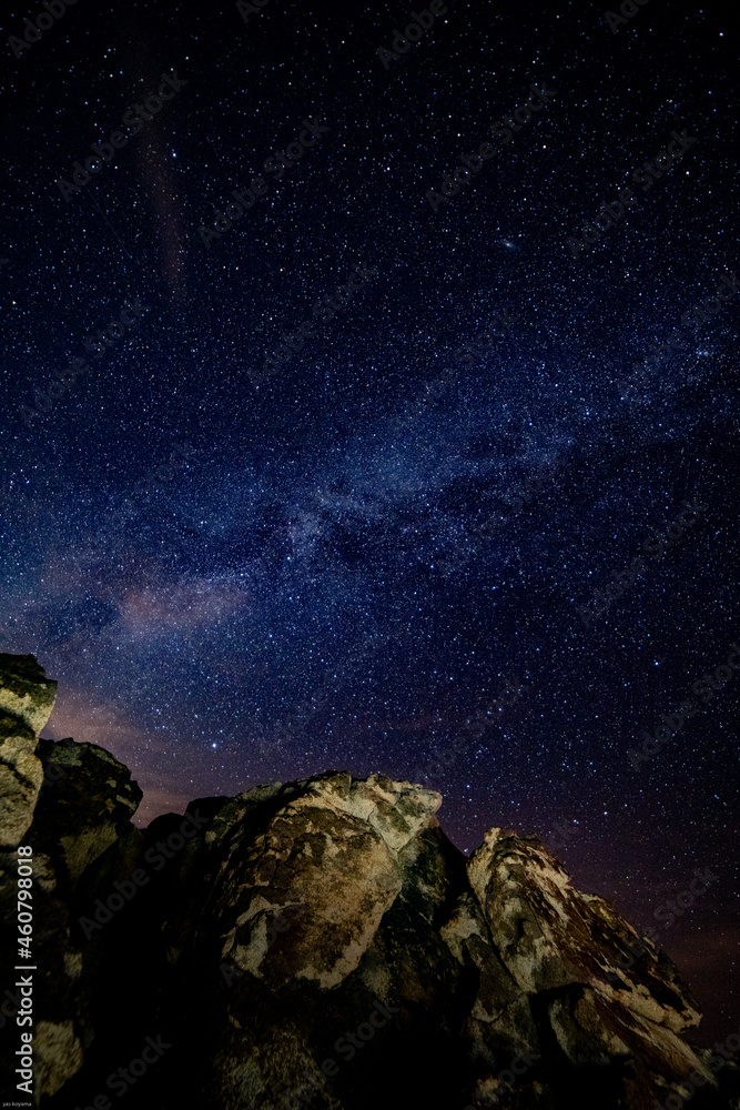 Sticker Beautiful shot of a rock under the starry night sky