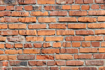 Red brick wall texture. Old facade of a building with concrete joints, vintage background