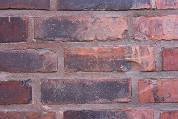 Texture of a red brick wall wall in a closeup.