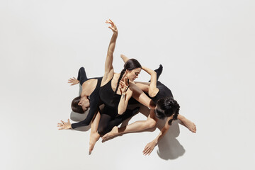 High angle view. Modern ballet performance. Group of modern dancers, art contemp dance, black and white, combination of emotions