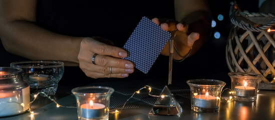 Tarot cards, Fortune telling on tarot cards at night by candlelight, magic crystal, occultism, Esoteric background. Fortune telling, tarot predictions.