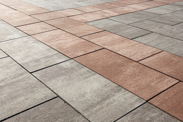 Paving with large gray and brown paving slabs. Selective focusing.