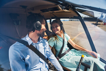 Couple seated in private chopper before take-off © Svitlana