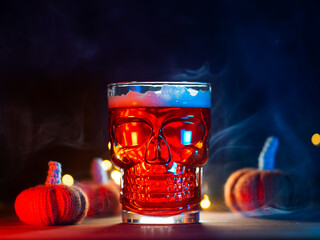 Scary glass of beer in the shape of a skull, Halloween party. Craft beer, pumpkin ale