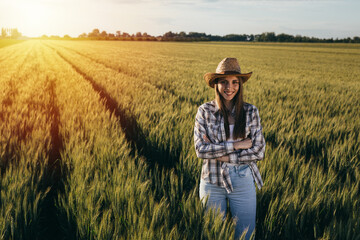 Naklejka na ściany i meble woman farmer standing in wheat field