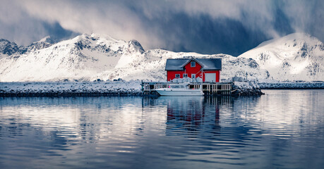 Panoramic winter view of small fishing village - Ramberg, Lofoten Islands, Norway, Europe. Dramatic morning seascape of Norwegian sea, Rambergsvika fjord. Cold outdoor scene over polar circle. © Andrew Mayovskyy