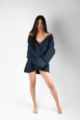 Attractive asian woman in jacket posing on white background.