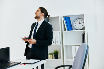 man in a suit in the office with documents technologies