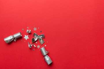 Christmas crackers with shiny confetti on color background, top view, copy space