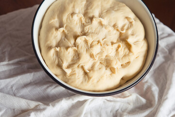 Process of raising the dough in a special basket. Dough made from natural sourdough. Wheat dough. Fermentation. Top view.	