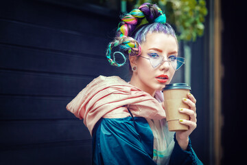 Cool funky young girl with piercing and crazy hair enjoy takeaway coffee on street - 460808298