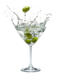 Martini glass with amazing splash from olive berries falling down in it. White background.