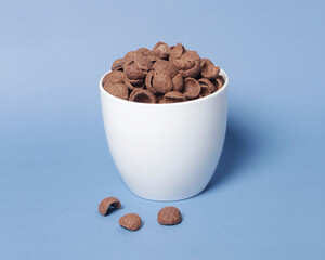 Chocolate flavored cereal for breakfast to start your morning. These foods are generally eaten cold, and eaten with milk, water or yogurt, or eaten alone. Nutritious cereal. Cereal mockup. Focus blur.