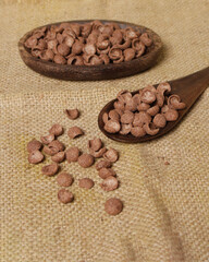 Chocolate flavored cereal for breakfast to start your morning. These foods are generally eaten cold, and eaten with milk, water or yogurt, or eaten alone. Nutritious cereal. Cereal mockup. Focus blur.