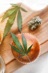 Delicious homemade muffin with CBD cannabis and leaf garnish. Medicinal Edibles. Treatment of medical marijuana for use in food. Canada legalization. Rasta muffin
