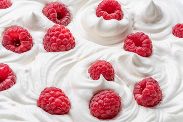 Fresh raspberries in the yoghurt or cream. Top view.