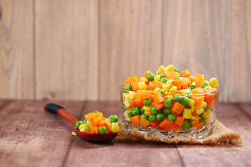  corn, carrot and beans in a bowl on table with copy space 