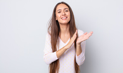 hispanic pretty woman feeling happy and successful, smiling and clapping hands, saying...