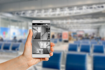 Tourist using mobile phone with app for video surveillance system in airport