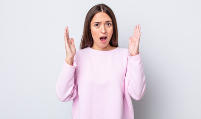 hispanic pretty woman looking shocked and astonished, with jaw dropped in surprise when realizing...