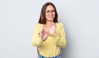 hispanic pretty woman feeling disgusted and nauseous, backing away from something nasty, smelly or...